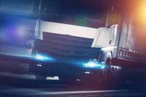 Speeding Modern Semi Truck Concept Photo. Euro Tracking and Spedition Theme.