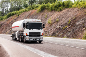 White truck moving by a road