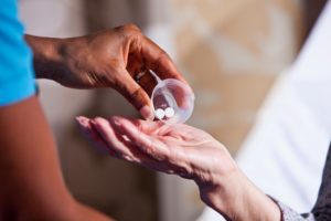 Image of a woman in a nursing home receiving her medication