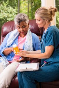 Image of old woman and nurse in a nursing home